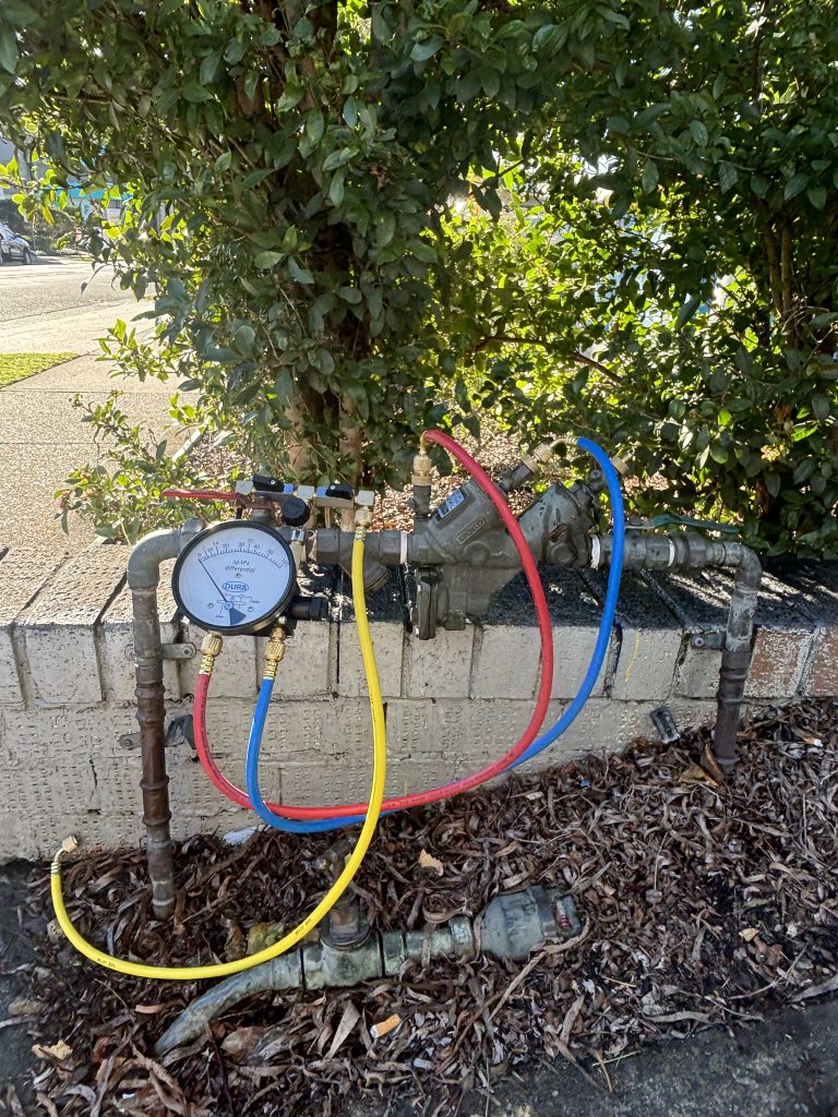back flow prevention system near bushes