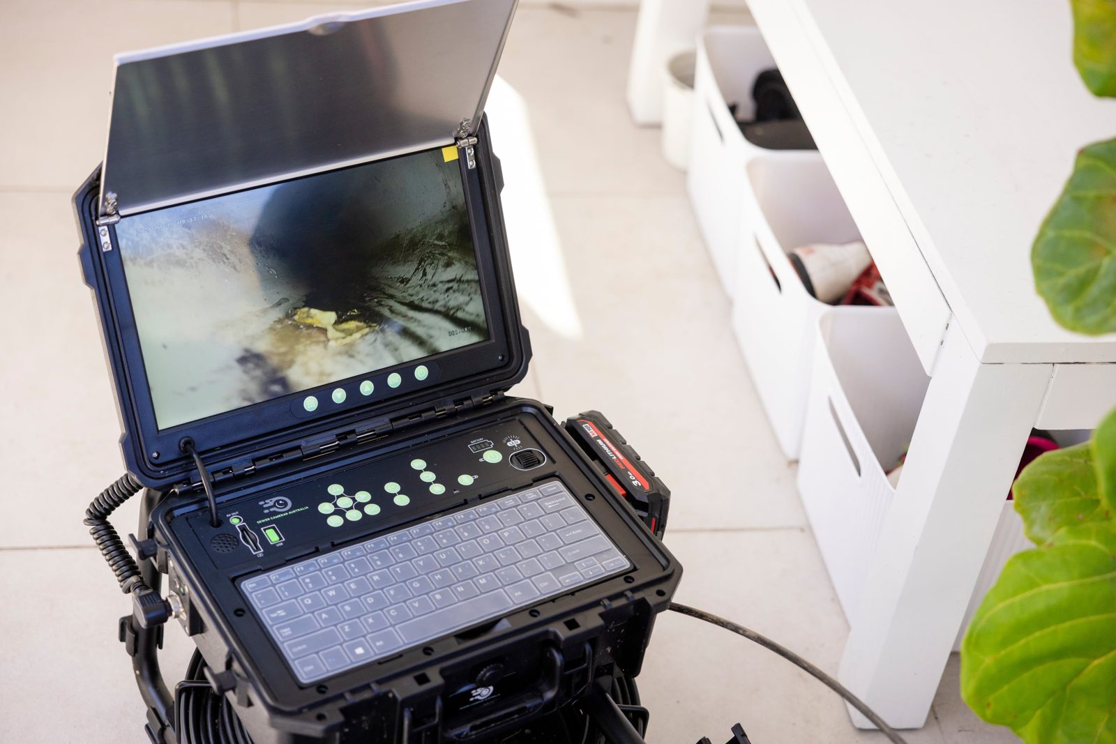 CCTV drain camera monitor showing a blockage inside a household drain pipe